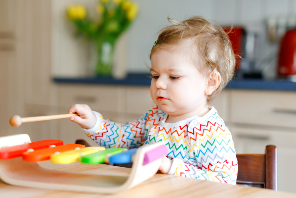 toddler playing with xylophone