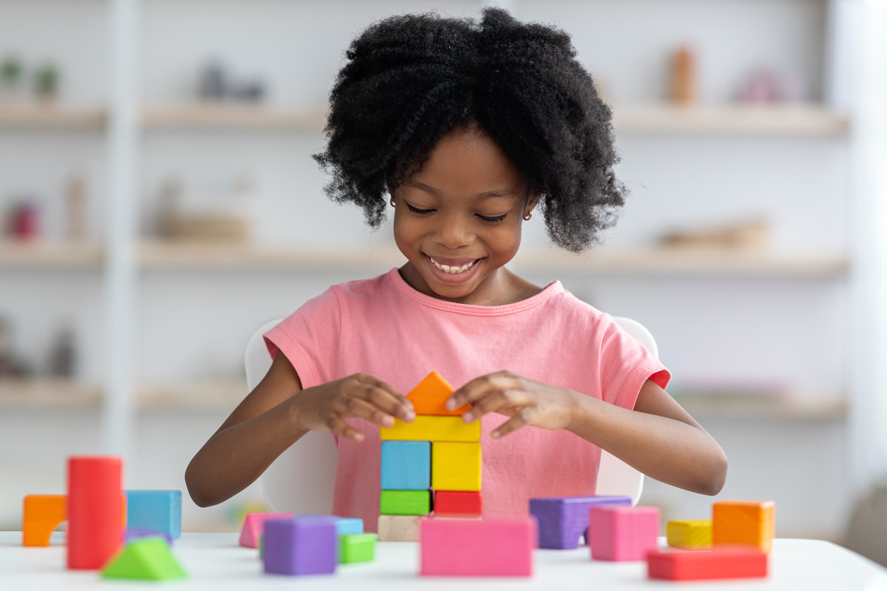 child playing with colorful blocks